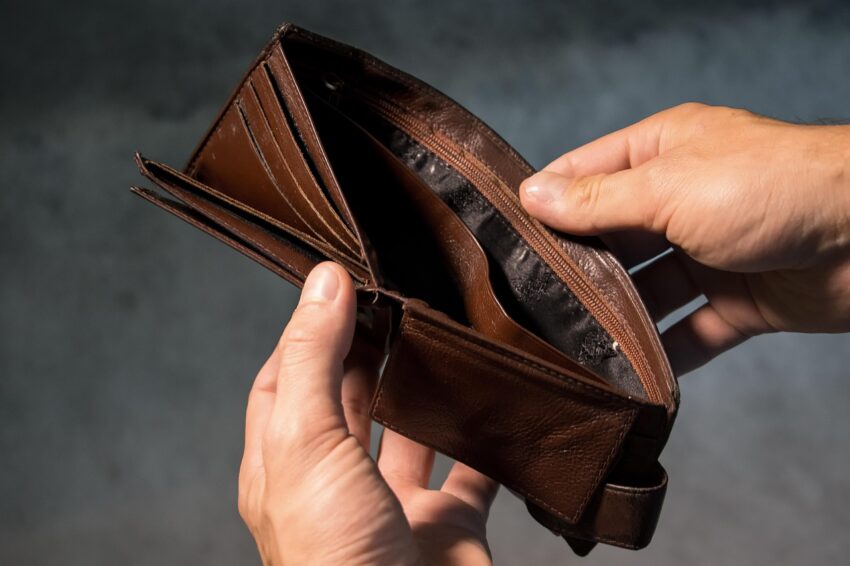 Surprising things I learned from my no-buy challenge: a man holding an empty wallet.