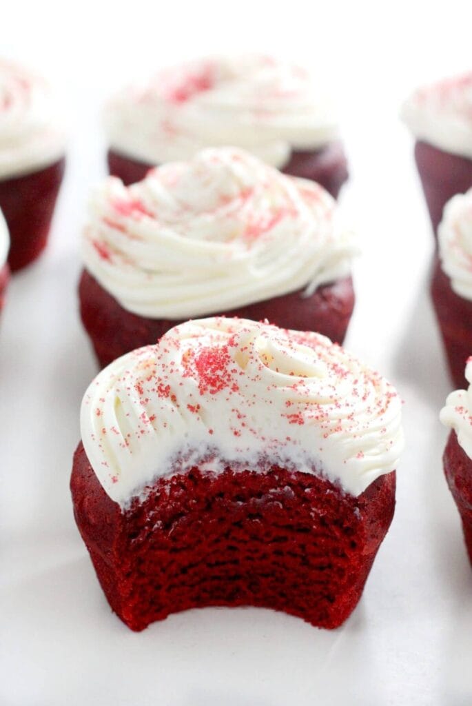 Gluten-Free Red Velvet Cupcakes topped with creamy white frosting and red sprinkles, a festive and delicious choice for Valentine's Dessert Ideas.