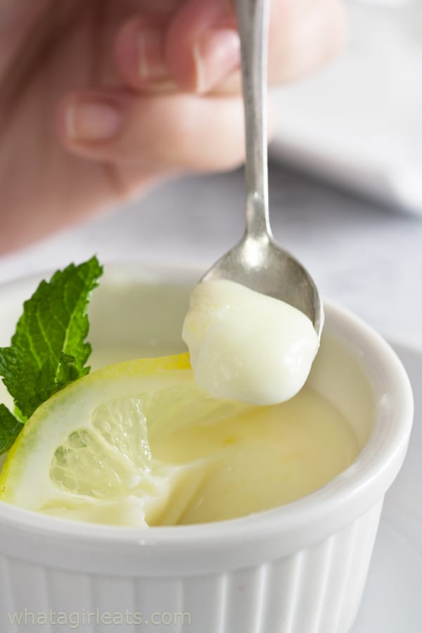 A creamy Lemon Posset served in a white ramekin, garnished with a fresh lemon slice and mint leaf, perfect for Valentine's Dessert Ideas.