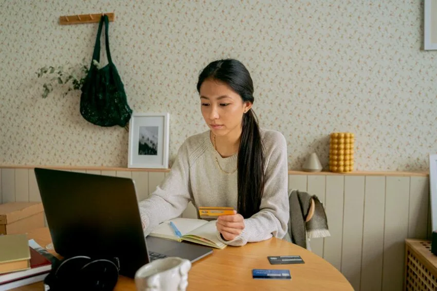 woman in gray sweater online shopping