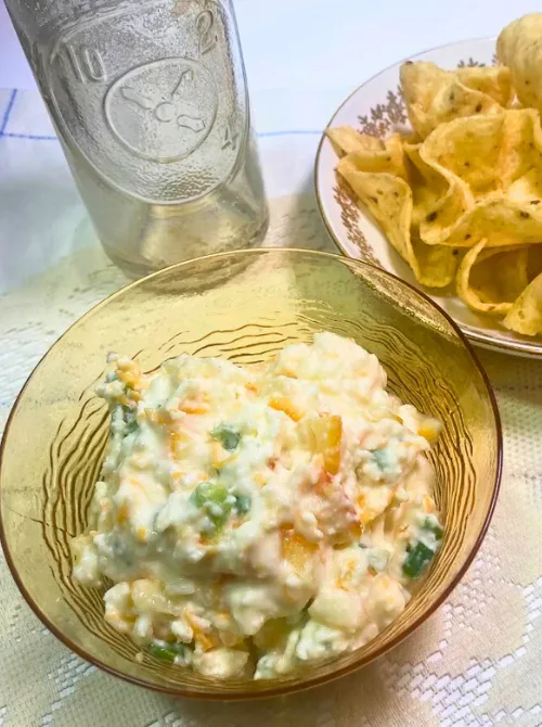 Creamy cheese and jalapeño dip served in a glass bowl with corn chips on the side—an easy and crowd-pleasing option for Super Bowl food ideas.