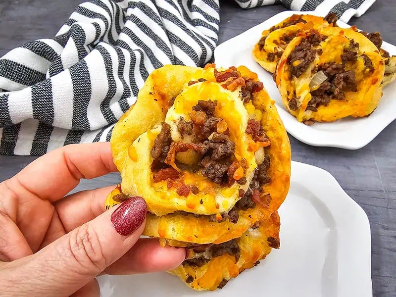 Cheesy beef pinwheels made with flaky dough, ground beef leftovers, bacon, and melted cheddar, perfect for a quick snack or appetizer.