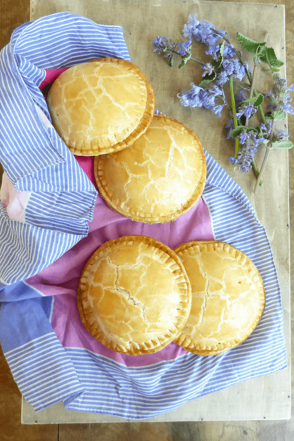 Golden hand pies, freshly baked and filled with turkey and vegetables, showcasing a zero-waste approach to leftovers recipes.