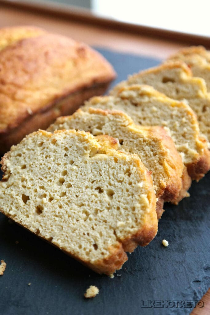 A loaf of golden bread, freshly sliced and made from leftover ingredients, showcasing a zero-waste approach to leftovers recipes.