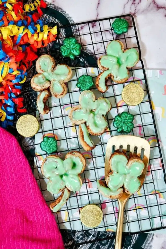 These shamrock-shaped pastries are decorated with a vibrant green glaze, making them a fun and festive treat for St. Patrick's Day food ideas. Perfect for celebrations, they add a whimsical touch to your collection of Irish recipes.