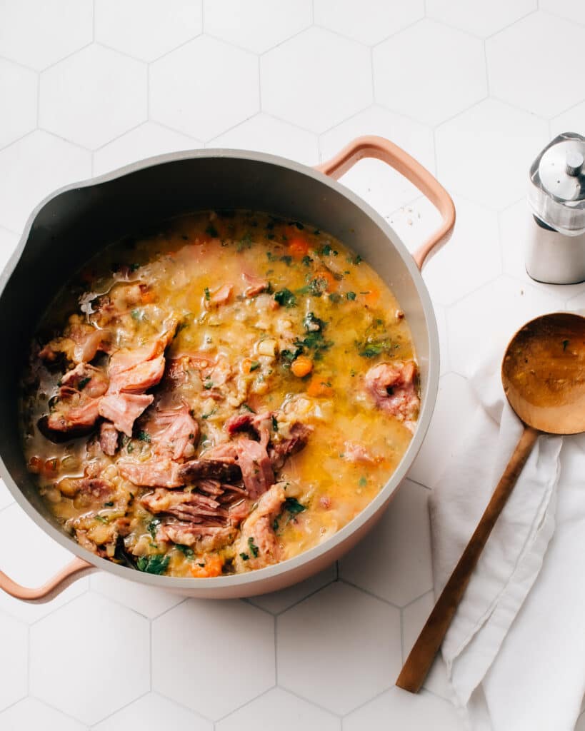 Pot of homemade ham and lentil soup, filled with tender ham chunks, lentils, and herbs, ideal for comforting and quick meals with ham.