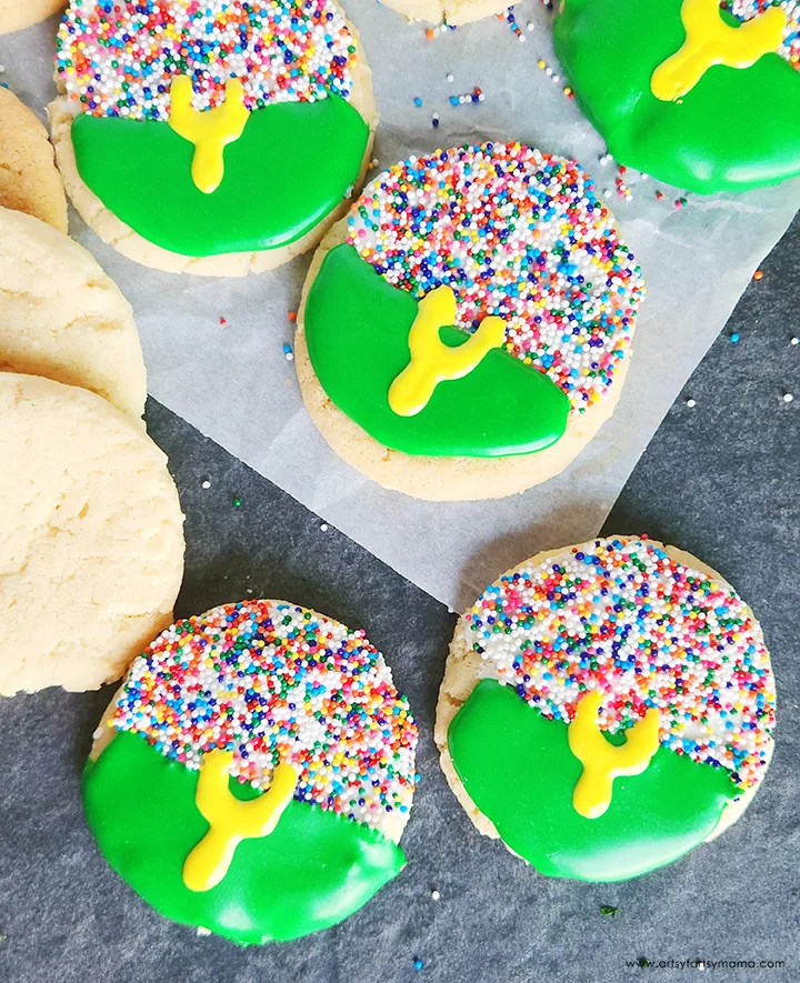 Football-themed sugar cookies decorated with green icing, colorful sprinkles, and yellow goalpost designs. A festive and sweet Super Bowl food idea perfect for game day desserts.