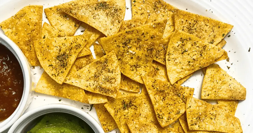 Close-up of seasoned tortilla chips, perfect for serving with the best party dips, showcasing a crispy texture and vibrant seasoning for a festive snack table.