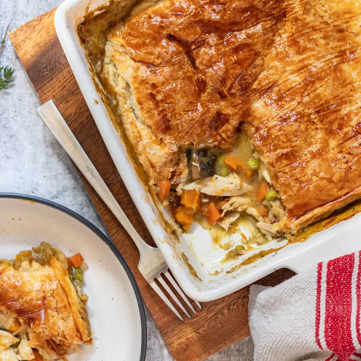 Golden turkey pot pie with carrots, peas, and a flaky pastry crust, highlighting a zero-waste approach to leftovers recipes.