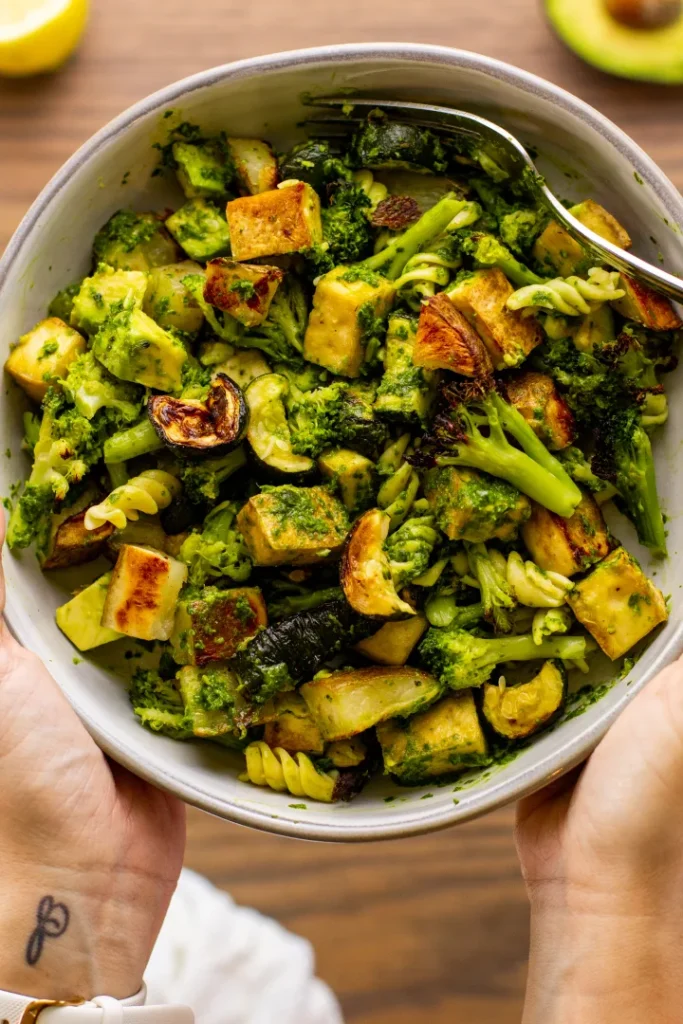 Vibrant bowl of roasted vegetables, pasta, and broccoli tossed in a green herb sauce, perfect for St. Patrick's Day food ideas and Irish recipes inspired by fresh and wholesome ingredients.