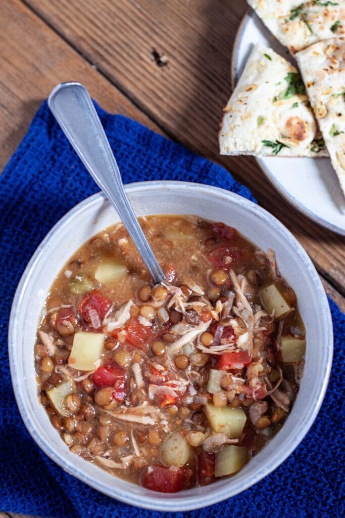 A hearty turkey and lentil soup with potatoes and tomatoes, highlighting a zero-waste approach to leftovers recipes.