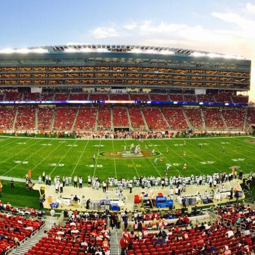 nfl stadium field full with crowd watching the game during daytime