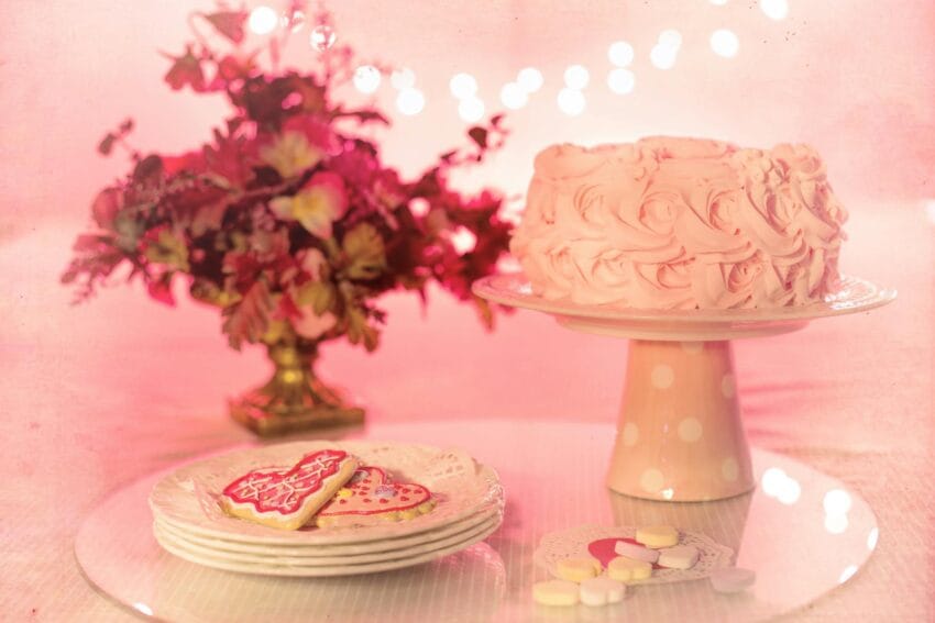 pink icing cake on cake stand