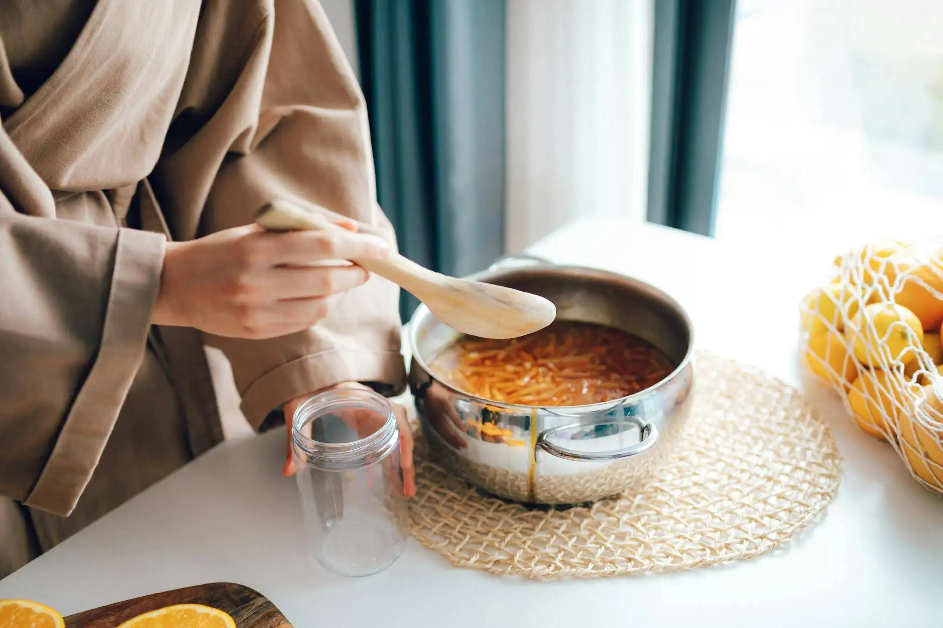 A person stirring a homemade pot of soup with a wooden spoon, preparing a farm-to-table dinner using fresh ingredients sourced from the farmer's market in a cozy home setting.