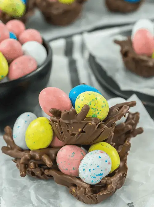 Chocolate bird’s nest cookies filled with colorful candy eggs—perfect for easy Easter finger food ideas and a fun, festive springtime treat!
