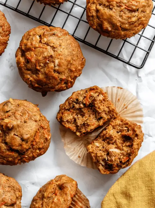 Freshly baked carrot muffins cooling on a wire rack, moist and fluffy, ideal for a budget-friendly Easter brunch.