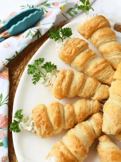 Golden, flaky puff pastry carrots filled with a creamy herb cheese filling and topped with fresh parsley—perfect for easy Easter finger food ideas. A festive holiday appetizer!