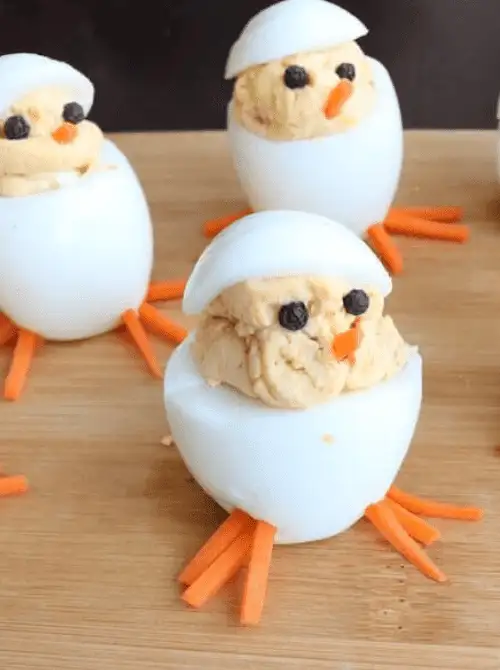 Adorable deviled egg chicks made with creamy filling, carrot feet, and peppercorn eyes—perfect for easy Easter finger food ideas. A fun and festive holiday appetizer!