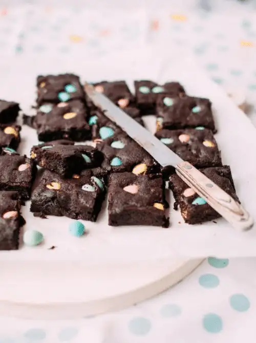Rich and fudgy Easter brownies studded with pastel chocolate candies—perfect for easy Easter finger food ideas and a festive holiday dessert!