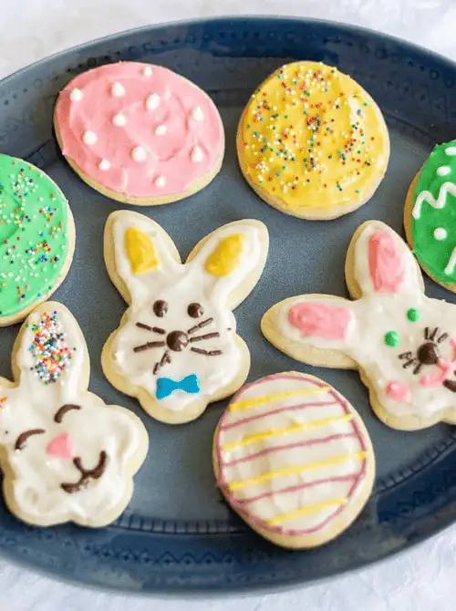 Festive Easter sugar cookies decorated with colorful icing in bunny and egg shapes—perfect for easy Easter finger food ideas and a fun holiday baking activity!