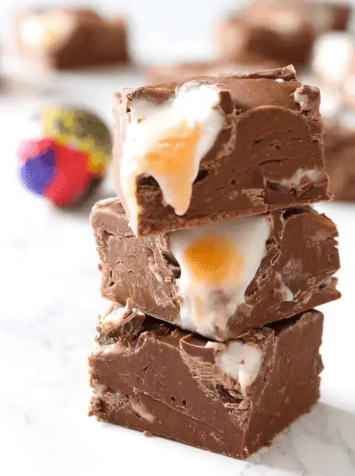 Creamy chocolate fudge infused with gooey Cadbury Creme Egg filling—perfect for easy Easter finger food ideas and a decadent holiday dessert!
