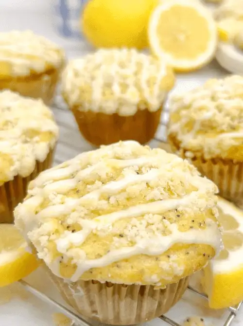 Freshly baked lemon poppy seed muffins drizzled with glaze and topped with crumble, perfect for a budget-friendly Easter brunch.