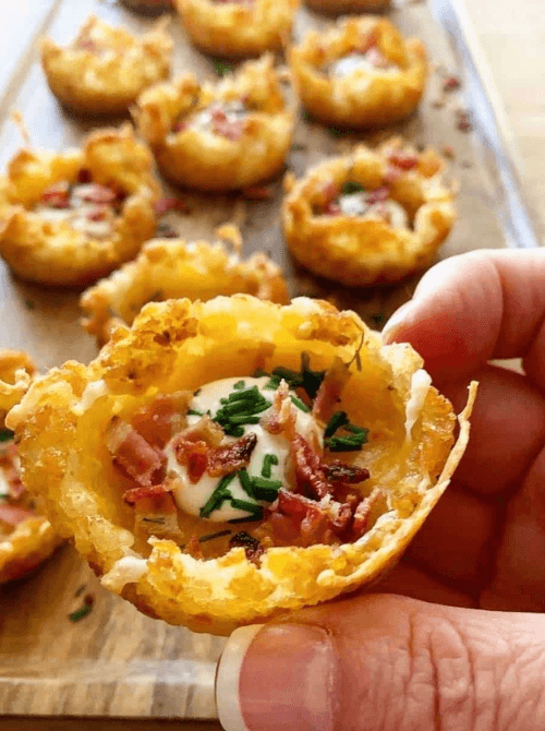 Crispy loaded tater tot cups filled with sour cream, bacon, and chives—perfect for easy Easter finger food ideas. A delicious bite-sized appetizer for spring gatherings.