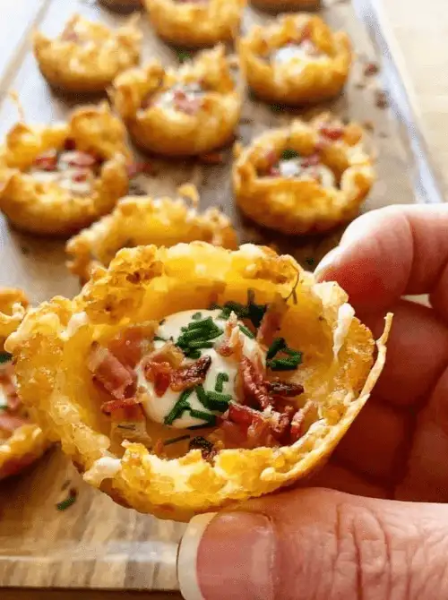 Crispy loaded tater tot cups filled with sour cream, bacon, and chives—perfect for easy Easter finger food ideas. A delicious bite-sized appetizer for spring gatherings.