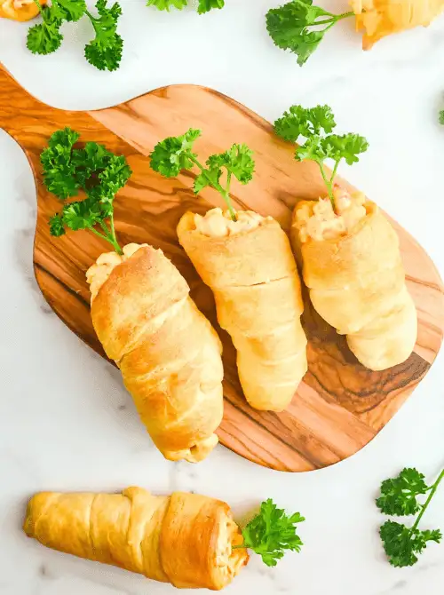Flaky crescent roll carrots filled with a creamy, savory filling and topped with fresh parsley—perfect for easy Easter finger food ideas. A festive and fun holiday appetizer!