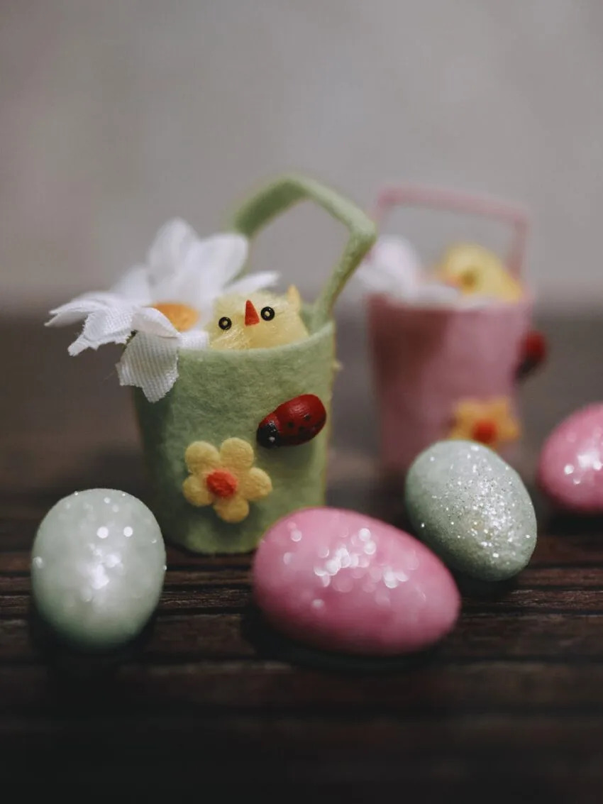 eggs and a basket with a chick on a table