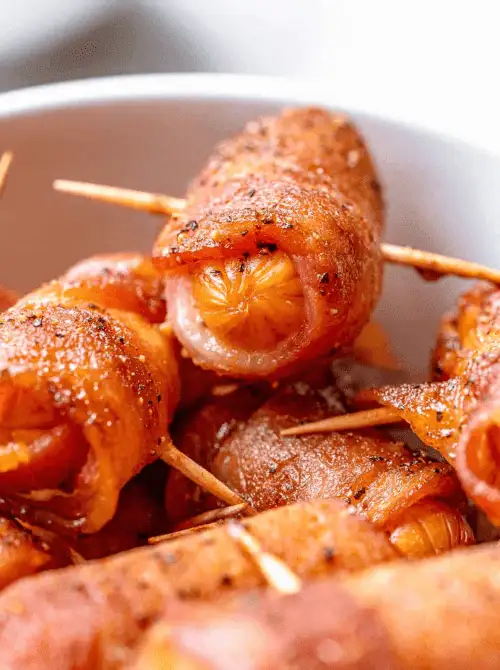 Savory bacon-wrapped smokies, perfectly caramelized and secured with toothpicks, offer a bold, flavorful bite that adds a touch of indulgence to your Mother's Day tea party ideas.