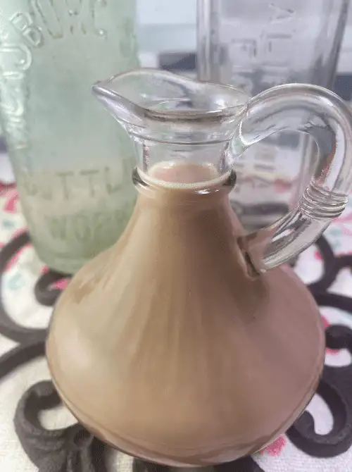 Glass jar filled with Honey Almond Fluff Creamer, a sweet and creamy homemade addition perfect for elevating any Mother's Day Tea gathering.