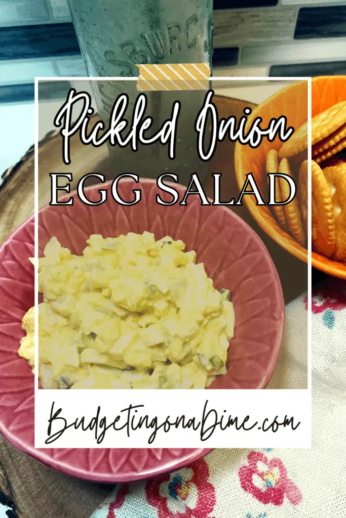 Graphic image featuring a bowl of Pickled Onion Egg Salad with crackers on the side, styled on a wooden tray, with the text 'Pickled Onion Egg Salad' and Budgetingonadime.com overlayed.