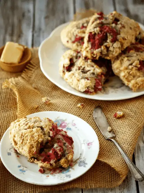 Homemade raspberry oatmeal scones served on vintage floral china with butter on the side—wholesome, comforting, and perfect for heartfelt Mother's Day tea party ideas.