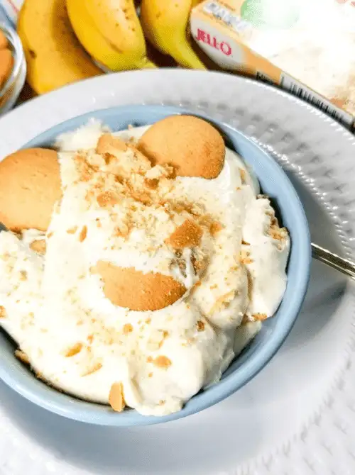 Creamy no-bake banana pudding served in a blue bowl, layered with vanilla wafers and whipped topping—an easy 4th of July dessert that’s classic, comforting, and perfect for summer gatherings.