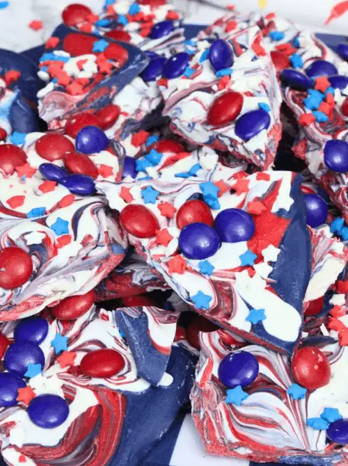 Swirled red, white, and blue candy bark topped with patriotic sprinkles and chocolate candies—an easy 4th of July dessert that’s colorful, festive, and completely no-bake.