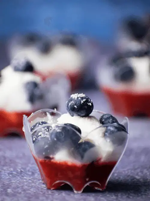 Mini no-bake dessert cups layered with strawberry puree, whipped topping, and fresh blueberries—an easy 4th of July dessert that’s patriotic, refreshing, and perfect for individual servings.