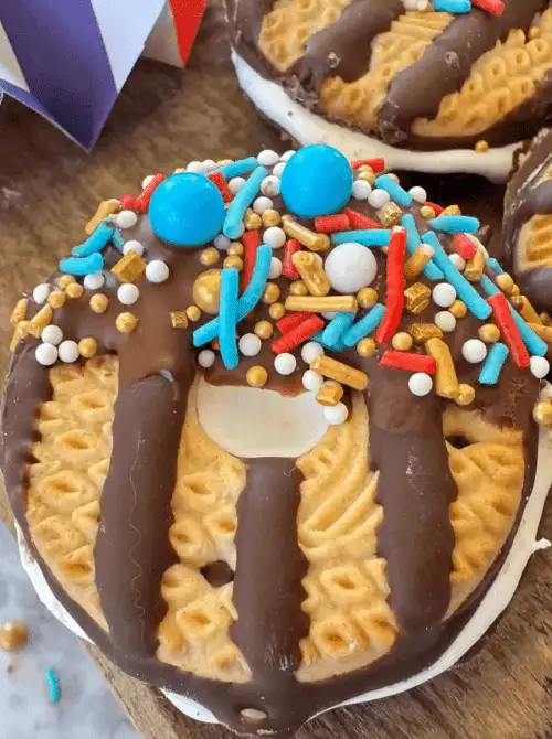 Patriotic no-bake cookie sandwiches dipped in chocolate and covered in red, white, and blue sprinkles—an easy 4th of July dessert perfect for kids and party trays.