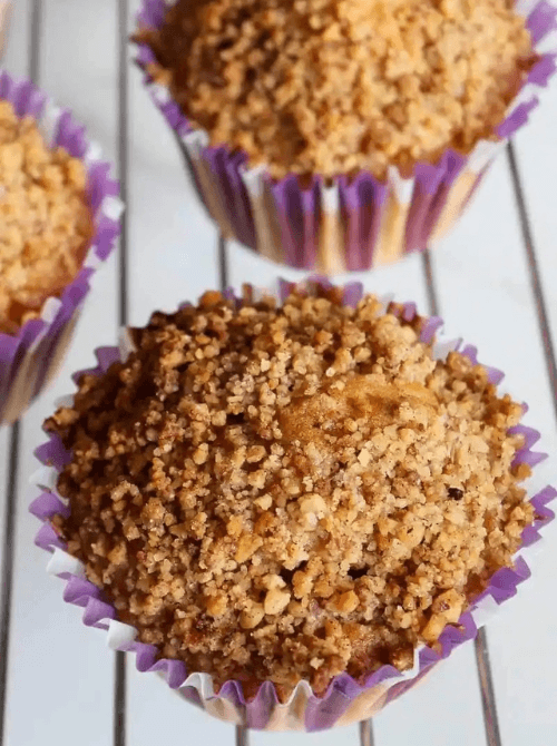 Apple cinnamon muffins topped with a golden walnut crumble, perfect for cozy mornings and a delicious answer to what to make with apples or fall bread recipes.