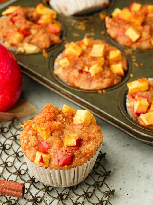 Freshly baked apple cinnamon muffins topped with diced apples and crumb topping—an inviting fall bread recipe and a delicious way to use up apples this season.