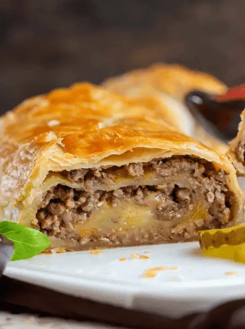 Cheeseburger puff pastry stuffed with seasoned ground beef and melted cheese—hearty tailgate food on a budget that’s easy to slice and serve to a crowd.