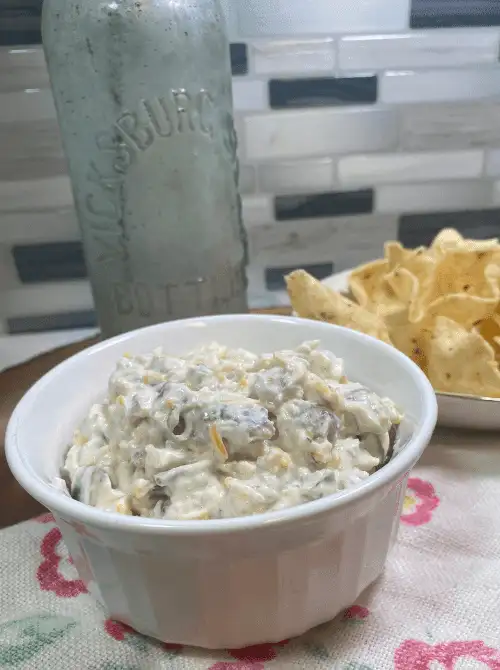 Creamy Cheeseburger Ranch Dip served in a white ramekin with tortilla chips in the background—perfect for easy, budget-friendly game day dips.