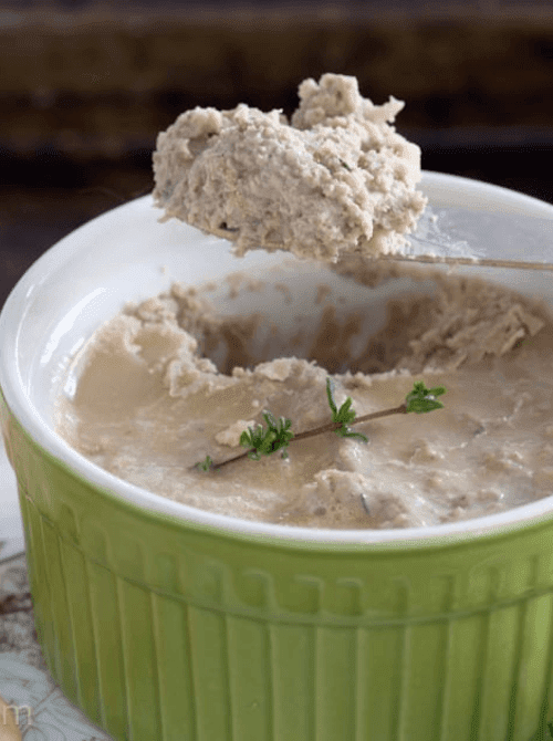 Savory apple and herb pâté served in a green ramekin, topped with a sprig of thyme—an unexpected yet elegant choice for easy fall recipes and creative things to make with apples.