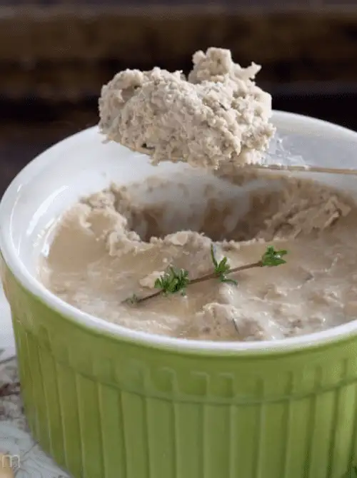 Savory apple and herb pâté served in a green ramekin, topped with a sprig of thyme—an unexpected yet elegant choice for easy fall recipes and creative things to make with apples.