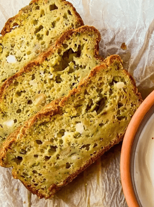 Slices of moist apple pumpkin snack bread with visible bits of fruit and seeds—an easy fall bread recipe and a tasty idea for what to make with apples.