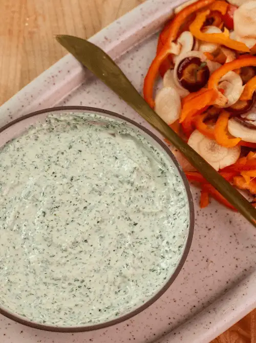 Creamy herb dip served with sliced rainbow carrots and bell peppers—an irresistible choice among easy game day dips for veggie lovers.