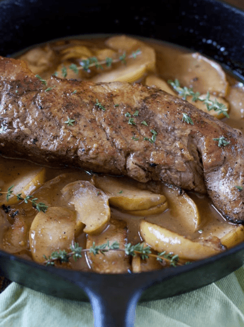 Skillet pork tenderloin simmered with sliced apples and fresh thyme in a savory pan sauce—a hearty, one-pan dinner that’s both flavorful and budget-friendly for easy fall recipes and comforting things to make with apples.