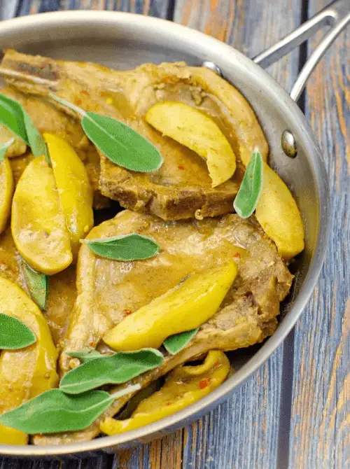 Pan-seared pork chops with golden apple slices and fresh sage in a savory skillet sauce—a rustic and flavorful dinner idea that’s perfect for easy fall recipes and hearty things to make with apples.
