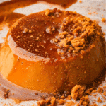 Vegan pumpkin flan topped with rich caramel sauce and crushed cookies—an elegant and creamy fall dessert made with leftover pumpkin puree.
