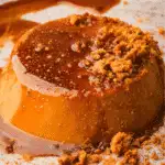 Vegan pumpkin flan topped with rich caramel sauce and crushed cookies—an elegant and creamy fall dessert made with leftover pumpkin puree.